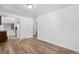 Expansive living room with wood-look floors, white walls, that flows into the kitchen area at 1235 S Benton St, Lakewood, CO 80232