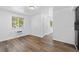Open living room showcasing laminate flooring and natural light from large windows at 1235 S Benton St, Lakewood, CO 80232