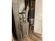 Mechanical room featuring furnace and water heater, providing essential home systems at 1235 S Benton St, Lakewood, CO 80232