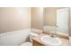 Charming powder room featuring wainscoting and a marble-topped vanity with a bright mirror at 19232 E Adriatic Pl, Aurora, CO 80013