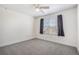 Well-lit bedroom with neutral carpeting, gray walls, and a large window offering views at 19232 E Adriatic Pl, Aurora, CO 80013