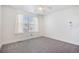 Bright bedroom with a ceiling fan, gray carpet, and window with white blinds and curtain at 19232 E Adriatic Pl, Aurora, CO 80013