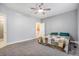 Cozy bedroom with a ceiling fan, a patterned quilt on the bed, and an open doorway at 19232 E Adriatic Pl, Aurora, CO 80013