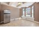 Inviting dining area with a window seat, tile floors, and a stylish stainless-steel refrigerator at 19232 E Adriatic Pl, Aurora, CO 80013