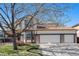 Charming two-story home with a three-car garage, brick accents, and a manicured lawn at 19232 E Adriatic Pl, Aurora, CO 80013