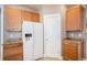 Functional kitchen area showcasing wood cabinets, ample counter space, and a modern, updated refrigerator at 19232 E Adriatic Pl, Aurora, CO 80013