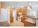 Well-lit kitchen featuring wood cabinetry and tile flooring at 19232 E Adriatic Pl, Aurora, CO 80013