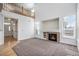 Spacious living room with vaulted ceilings, a cozy fireplace, large windows, and a catwalk above at 19232 E Adriatic Pl, Aurora, CO 80013