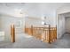 Bright upstairs landing and loft area with wooden railing and stairwell at 19232 E Adriatic Pl, Aurora, CO 80013