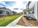 A spacious backyard features a paved walkway, lush landscaping, and a privacy fence for relaxation and enjoyment at 1308 E Hopkins Dr, Elizabeth, CO 80107