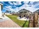 A backyard features a patio with comfortable chairs, a well-manicured lawn, and a stylish retaining wall at 1308 E Hopkins Dr, Elizabeth, CO 80107