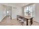 Bright dining room features light wood floors, a table with seating, and natural light from a large window at 1308 E Hopkins Dr, Elizabeth, CO 80107