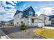 A charming two-story home featuring a covered porch and a spacious three-car garage at 1308 E Hopkins Dr, Elizabeth, CO 80107