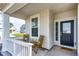 Inviting front porch with cozy seating and a 'Welcome' mat at 1308 E Hopkins Dr, Elizabeth, CO 80107