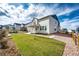 A well-manicured front yard features a lush lawn, a charming porch, and a welcoming entrance to the home at 1308 E Hopkins Dr, Elizabeth, CO 80107
