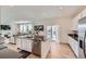 Bright kitchen with white cabinets, a center island, and an open layout to the living space at 1308 E Hopkins Dr, Elizabeth, CO 80107