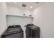 Laundry room featuring modern, front-load washer and dryer set at 1308 E Hopkins Dr, Elizabeth, CO 80107