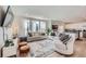 Bright living room with large windows, hardwood floors, and comfortable seating arrangements at 1308 E Hopkins Dr, Elizabeth, CO 80107