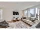 Comfortable living room showcasing a sofa, area rug, and bright natural light at 1308 E Hopkins Dr, Elizabeth, CO 80107