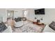 Well-lit living room featuring hardwood floors, comfortable furniture and dining area in the background at 1308 E Hopkins Dr, Elizabeth, CO 80107