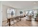 Open-concept living room features light wood floors, modern furnishings, and plenty of natural light at 1308 E Hopkins Dr, Elizabeth, CO 80107