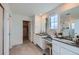 Spacious main bathroom with dual sinks, vanity, tile floors, and glass enclosed shower at 1308 E Hopkins Dr, Elizabeth, CO 80107