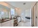 Bathroom features dual sinks, spacious vanity with mirrors, and glass shower door, plus access to bedroom at 1308 E Hopkins Dr, Elizabeth, CO 80107
