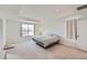 Bright bedroom boasts tray ceilings, plush carpet, and a comfy bed, creating a relaxing retreat at 1308 E Hopkins Dr, Elizabeth, CO 80107