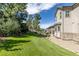 Expansive backyard showcasing a lush green lawn, stone-lined flowerbeds, and a patio area, offering ample space for outdoor enjoyment at 6728 S Catawba Way, Aurora, CO 80016