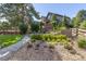 Beautifully landscaped backyard featuring a stone pathway, patio with seating, and a wooden fence, all surrounded by greenery at 6728 S Catawba Way, Aurora, CO 80016