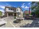 Backyard with a stone patio, fire pit, outdoor seating, and a view of the home's exterior under a sunny sky at 6728 S Catawba Way, Aurora, CO 80016