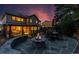 Backyard featuring a stone fire pit, patio, covered porch, mature landscaping, and an open yard at 6728 S Catawba Way, Aurora, CO 80016