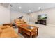 Finished basement provides plush carpeting, recessed lighting, comfortable seating, and a large television at 6728 S Catawba Way, Aurora, CO 80016