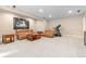 Finished basement boasts carpeting, recessed lighting, a cozy seating area, and a treadmill for exercising at 6728 S Catawba Way, Aurora, CO 80016