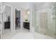 Bright bathroom features a glass shower with a seat, a walk-in closet, and a fluffy rug at 6728 S Catawba Way, Aurora, CO 80016