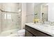 Well-lit bathroom featuring a single vanity, a large mirror, and a glass-walled walk-in shower at 6728 S Catawba Way, Aurora, CO 80016