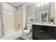 Bathroom featuring a shower and tub combination, updated vanity, decor, and a neutral color palette at 6728 S Catawba Way, Aurora, CO 80016