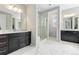 Bright bathroom featuring dual vanities, a large glass shower, and a walk-in closet at 6728 S Catawba Way, Aurora, CO 80016