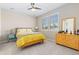 Bright bedroom features plantation shutters, a ceiling fan, and light wood furnishings at 6728 S Catawba Way, Aurora, CO 80016