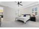 Spacious primary bedroom with a tray ceiling, plantation shutters, and an ensuite bathroom at 6728 S Catawba Way, Aurora, CO 80016