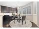 Bright breakfast nook featuring plantation shutters, a modern chandelier, and an adjacent desk area at 6728 S Catawba Way, Aurora, CO 80016