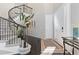 Inviting entryway with curved staircase, dark hardwood floors, and stylish decor at 6728 S Catawba Way, Aurora, CO 80016