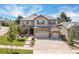 Stunning two-story home with stone accents, a three-car garage, and beautifully landscaped front yard at 6728 S Catawba Way, Aurora, CO 80016