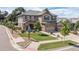 Charming two-story home with a three-car garage and well-manicured lawn on a sunny day at 6728 S Catawba Way, Aurora, CO 80016