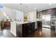 Open kitchen view showcasing large island, stainless appliances and connection to the living area at 6728 S Catawba Way, Aurora, CO 80016