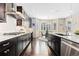 Gourmet kitchen with granite countertops, stainless steel appliances, and dark hardwood floors at 6728 S Catawba Way, Aurora, CO 80016