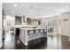 Spacious kitchen with a large island, dark cabinets, and stainless steel appliances at 6728 S Catawba Way, Aurora, CO 80016