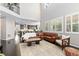 Bright living room boasts soaring ceilings, large windows, and dark hardwood floors throughout at 6728 S Catawba Way, Aurora, CO 80016