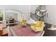 Spacious living room with a curved staircase, open dining area, and elegant furnishings at 6728 S Catawba Way, Aurora, CO 80016