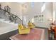 Bright living room with a curved staircase, two-story ceiling, and natural light at 6728 S Catawba Way, Aurora, CO 80016